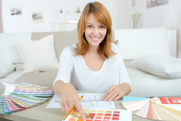 Lady looking at paint charts, pointing at choice