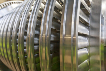 Important parts of steam turbine rotor at processing line in a factory workshop.