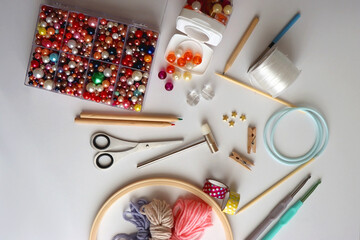 Various craft supplies on white background. Supplies for jewelry making, drawing and needlework....