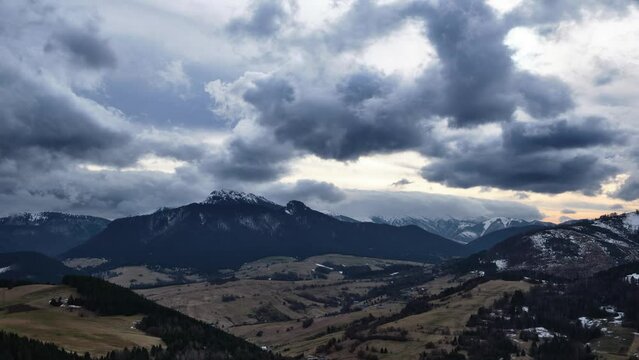 Rural mountain landscape between winter and spring, Cloudy weather, Clouds forming over the mountains, timelapse