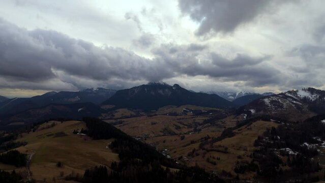 Mountain landscape in cloudy cloudy weather, Forests and pastures. End of winter. Hyperlapse, Aarial view,