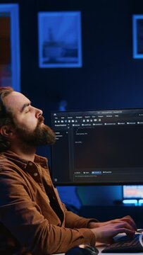 Software engineer doing programming using augmented reality visualization during remote job shift in home office. IT admin working on computer, looking at AR hologram, camera A