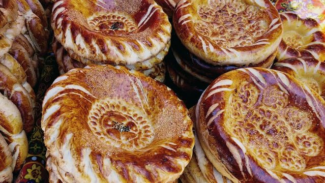 Tortillas on the market in Samarkand, Uzbekistan - June 29, 2023: Goods and traders at the Oriental Bazaar in Uzbekistan. Siab Bazaar is the largest and oldest bazaar in Samarkand. 4K