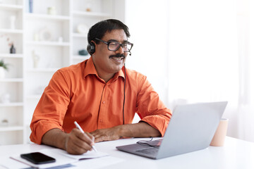 Concentrated mature indian man have online training