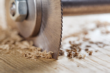 Circular saw cutting wooden plank. Circular milling in oak block.