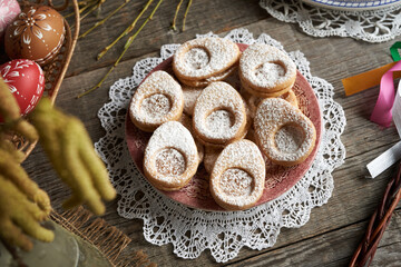 Homemade Linzer cookies in the shape of eggs, with Easter decoration