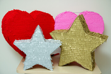 bright piñatas for birthday celebrations, hearts and stars made of cardboard