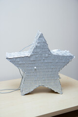 silver piñata star, star made of cardboard and paper, birthday decor
