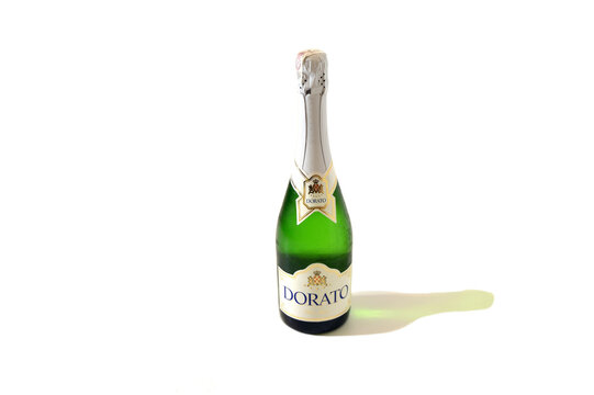 Kielce, Świętokrzyskie, Poland - 2022-11-18 - Dorato champagne on an isolated white background with the shadow of the reflection of the bottle falling to the right