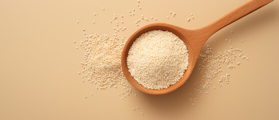 White Couscous Grains in a Wooden Ladle on a Beige Background