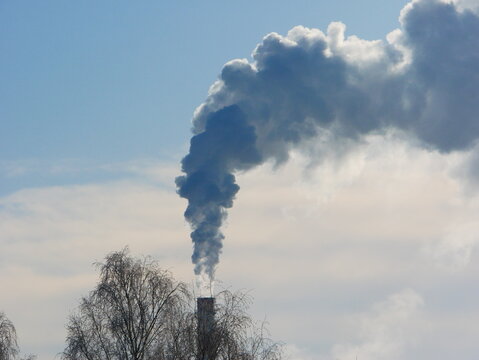 A smoking chimney against the sky.