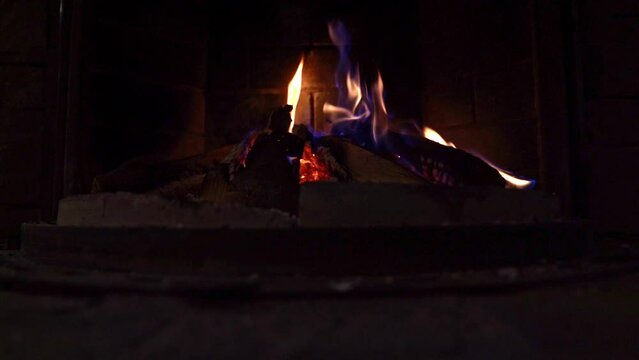 Idyllic view of cozy fireplace inside of restaurant in the Swiss Alps in the evening. Slow motion movie shot February 12th, Fronalpstock, Stoos, Canton Schwyz, Switzerland.