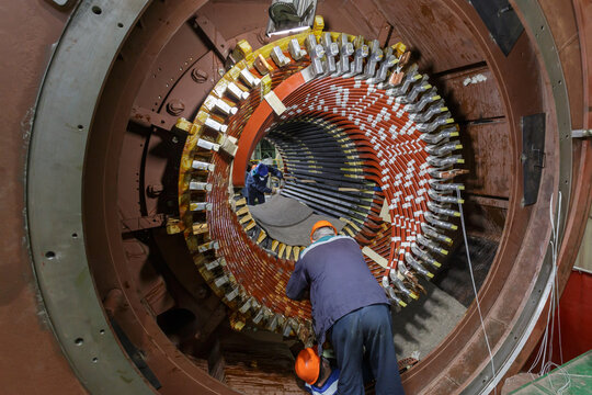 Assembling stator winding in factory workshop.