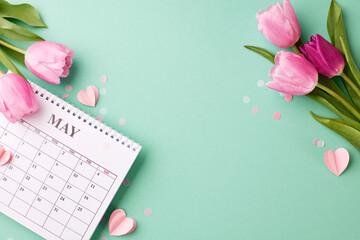 May's blossoming gratitude: honoring motherhood. Top view shot of vibrant tulips surrounding a calendar on a refreshing turquoise background with space for loving messages - obrazy, fototapety, plakaty