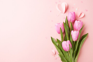 Eternal adoration: capturing the essence of love. Top view shot of pink tulips, heart-shaped decorations on a soft pink background with space for intimate message