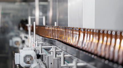 Brown glass beer drink alcohol bottles, brewery conveyor, modern industrial food production line banner with sunlight