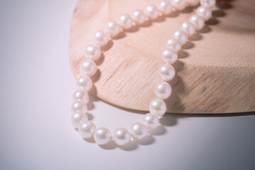 beautiful women's necklace made of natural white sea pearls on a light background