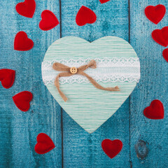 Valentines day greeting card template. Gift boxes, heart decor over blue wooden background. Top...