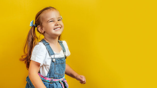 Image of Caucasian child posing on yellow background