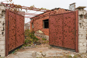 Closeup view of ruined facade of house in Mariupol.