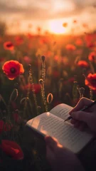 Fototapete Rund The hands of a person writing in a notebook in the middle of a field of red poppies at sunset during the golden hour, moments of reflection, creativity and inspiration amidst nature. © SnapVault