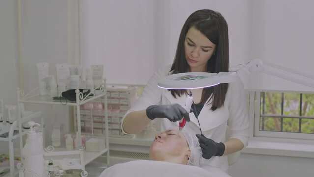 Close-up of a woman face. Needle mesotherapy procedure into the skin of the face