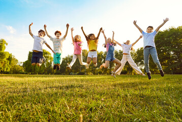 Children friends having fun on summer vacation. Overjoyed kids playing in park. Group of cheerful...