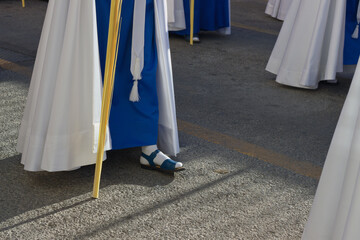 Sandals of some Nazarenes in blue tunic in a Palm Sunday procession in Spain