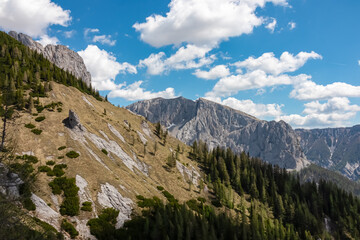 Obraz premium Panoramic view of majestic mountain peak Winkelkogel in untamed Hochschwab mountain range, Styria, Austria, Scenic hiking trail in remote Austrian Alps in summer. Escapism in wild nature. Wanderlust