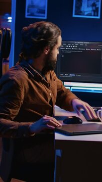 Software designer finishing remote job shift, packing backpack, leaving office after finishing coding project. IT professional putting laptop in bag, sitting up from desk chair, camera B