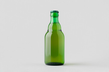 Green steinie beer bottle mockup on a grey background.