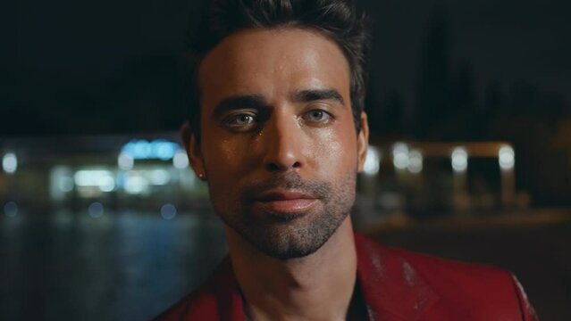 Portrait italian man posing at night street in red jacket. Rich businessman 