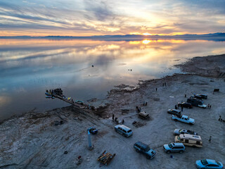 Sunset at Bombay Beach, California on the Salton Sea from a UAV Drone with the community enjoying the Sunset