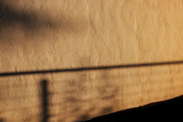 Ochre Wall Texture in Evening Light: Dark Shadows Cast an Enchanting Effect