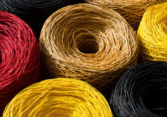 Raffia balls close-up. Skeins of multi-colored raffia are ready for knitting.