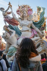Fototapeta na wymiar view from behind, a people view the impresionant monument of las fallas festivity in Valencia