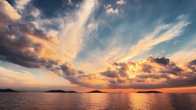 Stunning sunset painting the sky in shades of yellow and orange, casting a golden glow over tranquil ocean. Dramatic sunset over Princes Islands in Istanbul Turkey. Film-like LUT applied during record