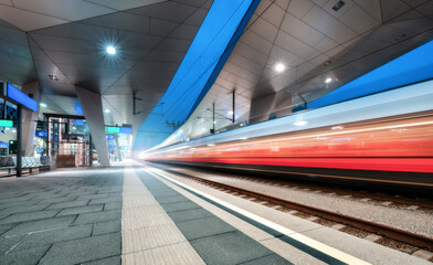 High speed train in motion on the railway station at night