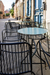 Empty street cafe tables and chairs in Old Town, Limassol, Cyprus 