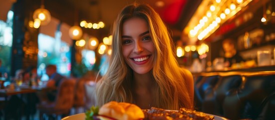 A young woman enjoying a delicious meal at a beautifully set table in a cozy restaurant