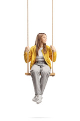 Teen girl sitting on a swing and looking to the side