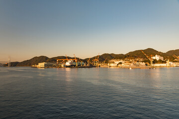 Fototapeta premium Nagasaki Bay, Nagasaki, Japan on a clear early morning with golden light