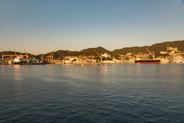 Fototapeta premium Nagasaki Bay, Nagasaki, Japan on a clear early morning with golden light