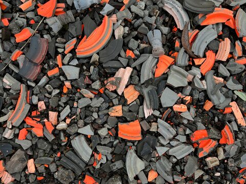 Clay pigeon targets broken over the ground black and orange