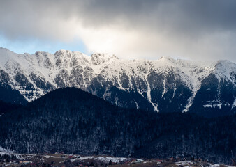 Winter panorama view over Piatra Craiului Mountains. Romanian mountains in winter. Snow covered Carpathians.