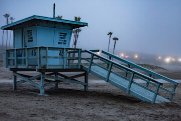 A lifeguard tower on a foggy beach