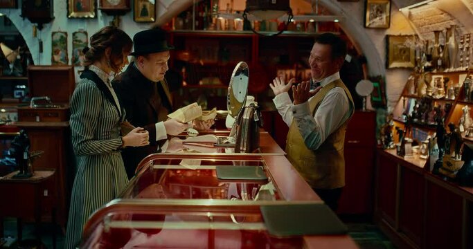 man and woman in pawn shop in 19 century, history of past time, 4K, Prores