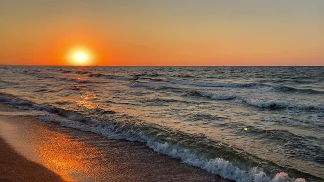 Sunset on the beach in Golubitskaya. Beautiful sunset on the background of the sea. Sunset landscape, amazing light of nature. The background of the nature environment.The Sea of Azov. Golubitskaya 4К