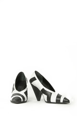 Women elegant pointy toe V cut mid kitten heels. Black and white leather shoes, product studio shot 