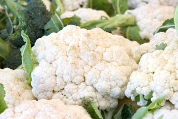Close up on a head of white cauliflower on display for sale at Farmer's Market.